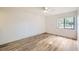 The bedroom has vinyl floors, a window and neutral colored walls, ready for new owners at 5321 Vineland Rd # 101, Orlando, FL 32811