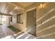 The condo entrance features unit number, neutral paint, and is illuminated by overhead lighting at 5321 Vineland Rd # 101, Orlando, FL 32811