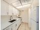 Well-lit kitchen with white cabinets, a stainless steel sink, and modern appliances at 5321 Vineland Rd # 101, Orlando, FL 32811