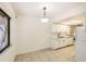 Open concept kitchen with bright white cabinets, stainless steel appliances and tile flooring at 5321 Vineland Rd # 101, Orlando, FL 32811