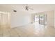 Bright living room with tile floors, ceiling fan, and sliding glass doors to an outdoor patio at 5321 Vineland Rd # 101, Orlando, FL 32811
