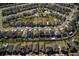 An aerial view of a vibrant residential neighborhood with well-maintained homes and community pool at 555 Meadow Bend Dr, Davenport, FL 33837