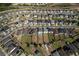 An aerial view showing an orderly residential neighborhood with single-Gathering homes near a tranquil pond at 555 Meadow Bend Dr, Davenport, FL 33837