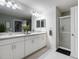 Bright bathroom with double vanity, white cabinets, and glass enclosed shower, creating a clean modern look at 555 Meadow Bend Dr, Davenport, FL 33837