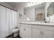 Bright bathroom featuring a shower/tub combo, white vanity and ample lighting at 555 Meadow Bend Dr, Davenport, FL 33837