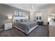 Serene bedroom featuring a king-size bed, neutral decor, soft carpet, and ample natural light at 555 Meadow Bend Dr, Davenport, FL 33837