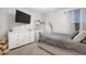 Bedroom with a bed, dresser, vanity, and a mounted television at 555 Meadow Bend Dr, Davenport, FL 33837