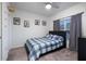 Cozy bedroom with a plaid bedspread, carpeted floor, stylish decor, and a window for natural light at 555 Meadow Bend Dr, Davenport, FL 33837