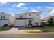 Charming two-story home with a well-maintained lawn, attached two-car garage, and covered entryway at 555 Meadow Bend Dr, Davenport, FL 33837