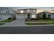 A beautiful two-story home with an attached garage, neat landscaping, and a welcoming entrance at 555 Meadow Bend Dr, Davenport, FL 33837