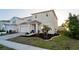 A charming two-story home featuring a well-kept lawn and an attached two-car garage on a sunny day at 555 Meadow Bend Dr, Davenport, FL 33837