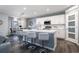 Modern kitchen featuring a central island, white cabinetry, stainless steel appliances, and pendant lighting at 555 Meadow Bend Dr, Davenport, FL 33837