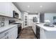 Bright kitchen featuring white cabinets, stainless appliances, and a center island with a wine cooler at 555 Meadow Bend Dr, Davenport, FL 33837