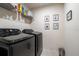 Functional laundry room with modern washer and dryer units; ample storage on wire shelving at 555 Meadow Bend Dr, Davenport, FL 33837