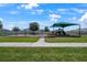 Community playground and park with swings, playground equipment, a covered picnic area and a grassy green at 555 Meadow Bend Dr, Davenport, FL 33837