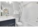 Bright bathroom with a white subway tile shower, modern vanity, and stylish fixtures at 5615 Wood Bridge Pl, St Cloud, FL 34771