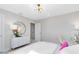 Airy bedroom with a dresser, stylish mirror, and decor that compliments the modern aesthetic at 5615 Wood Bridge Pl, St Cloud, FL 34771