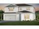 New two-story home with white siding, attached garage, and manicured front lawn at 5615 Wood Bridge Pl, St Cloud, FL 34771