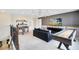 Upper level game room equipped with a shuffleboard, foosball table, cozy sofa, and a large TV at 5615 Wood Bridge Pl, St Cloud, FL 34771