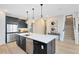 Kitchen with a large island, stainless steel appliances, and hardwood floors at 5615 Wood Bridge Pl, St Cloud, FL 34771