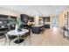 Modern, open kitchen with a spacious island, dark cabinetry, stainless steel appliances and a cozy dining area at 5615 Wood Bridge Pl, St Cloud, FL 34771