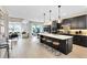 Open concept kitchen with a large island, modern appliances, and hardwood floors at 5615 Wood Bridge Pl, St Cloud, FL 34771
