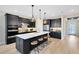 Modern kitchen featuring dark cabinets, a large island, and stainless steel appliances at 5615 Wood Bridge Pl, St Cloud, FL 34771