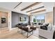 Living room with decorative beams, hardwood floors, and grey accent wall at 5615 Wood Bridge Pl, St Cloud, FL 34771