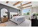 Bedroom featuring wood beam ceilings, a large window with a view, and neutral decor for a calming atmosphere at 5615 Wood Bridge Pl, St Cloud, FL 34771