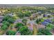 This aerial view highlights a serene residential area with beautiful homes surrounded by mature trees and green spaces at 609 Westview Dr, Minneola, FL 34715