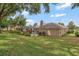 An expansive backyard with well-maintained landscaping and a screened-in pool, perfect for outdoor enjoyment at 609 Westview Dr, Minneola, FL 34715