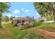 A sprawling backyard featuring a screened-in pool, lush landscaping, and serene outdoor living at 609 Westview Dr, Minneola, FL 34715