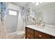 Bathroom with a shower-tub combo, vanity with ample storage, and a mirror with decorative lighting at 609 Westview Dr, Minneola, FL 34715