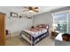 Cozy bedroom with a quilt-covered bed, natural light, and shelf space for displaying decor at 609 Westview Dr, Minneola, FL 34715