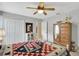 Comfortable bedroom featuring a vintage dresser and light gray walls, with ceiling fan and closet at 609 Westview Dr, Minneola, FL 34715