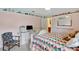Bright bedroom featuring colorful quilt, computer desk area, and whimsical decorative border at 609 Westview Dr, Minneola, FL 34715