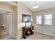 Inviting foyer with tile flooring, console table and ample natural light at 609 Westview Dr, Minneola, FL 34715