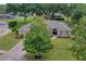 Beautifully landscaped home featuring a lush green lawn and mature trees at 609 Westview Dr, Minneola, FL 34715