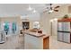 Bright kitchen with stainless steel appliances, a breakfast bar, and an open layout connecting to the dining area at 609 Westview Dr, Minneola, FL 34715