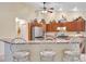 Modern kitchen with stainless steel appliances, a breakfast bar with seating, and ample cabinet space at 609 Westview Dr, Minneola, FL 34715