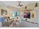 Cozy living room featuring plush seating, ceiling fan and a window view at 609 Westview Dr, Minneola, FL 34715