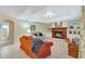 Inviting living room with a fireplace, comfortable seating, and access to the bathroom and other rooms of the home at 609 Westview Dr, Minneola, FL 34715