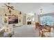 Bright living room with built-in shelving, vaulted ceilings, ceiling fan, and dining table, perfect for entertaining at 609 Westview Dr, Minneola, FL 34715