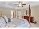 Tranquil main bedroom with a four-poster bed, soft lighting, and ensuite bathroom access at 609 Westview Dr, Minneola, FL 34715