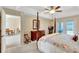 Inviting main bedroom features a four-poster bed, French doors, and neutral decor at 609 Westview Dr, Minneola, FL 34715