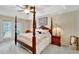Elegant main bedroom with a four-poster bed and French doors leading to the outdoors at 609 Westview Dr, Minneola, FL 34715