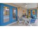 Cozy covered patio featuring bright blue doors, outdoor seating and a ceiling fan for comfort at 609 Westview Dr, Minneola, FL 34715