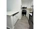 Bright kitchen featuring white cabinets, stainless steel appliances, and modern countertops at 6328 Raleigh St # 816, Orlando, FL 32835