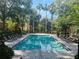 Community pool with sun loungers surrounded by lush landscaping at 6328 Raleigh St # 816, Orlando, FL 32835