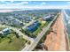 Expansive aerial view of a coastal town showcasing a blend of residential homes and beachfront condos along the shoreline at 7 Marden Dr, Ormond Beach, FL 32176